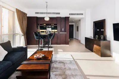 a living room with a couch and a table at One Bedroom Apartment Dubai Fountain & Old Town View by Auberge in Dubai