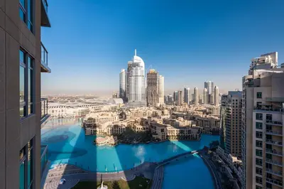 a view of a river in a city with tall buildings at One Bedroom Apartment Dubai Fountain & Old Town View by Auberge in Dubai