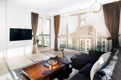 a living room with a couch and a table at One Bedroom Apartment Dubai Fountain & Old Town View by Auberge in Dubai