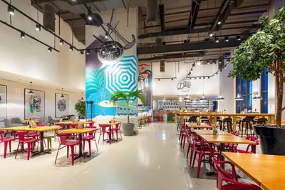 a restaurant with tables and chairs in a room at Rove Dubai Marina in Dubai