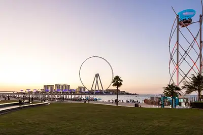a view of a beach with a ferris wheel in the background at ELAN Rimal 3 Suites in Dubai