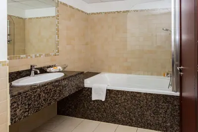 a bathroom with a tub and a sink at ELAN Rimal 3 Suites in Dubai