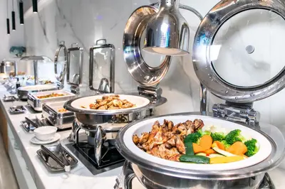 a buffet with a plate of food on a table at Marina Byblos Hotel in Dubai