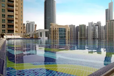 a swimming pool with a view of a city at Marina Byblos Hotel in Dubai