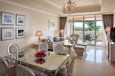 a living room with a table with fruit on it at Kempinski Hotel Palm Jumeirah in Dubai