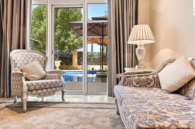 a living room with a couch and a chair at Kempinski Hotel Palm Jumeirah in Dubai