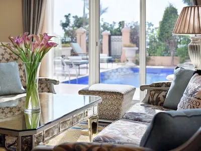 a living room with a vase of flowers on a table at Kempinski Hotel Palm Jumeirah in Dubai