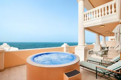 a hot tub on the balcony of a house at Kempinski Hotel Palm Jumeirah in Dubai