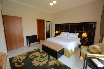 a bedroom with a large bed and a living room at Coral Boutique Villas in Dubai