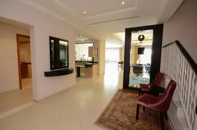 a hallway with chairs and a staircase with a mirror at Coral Boutique Villas in Dubai