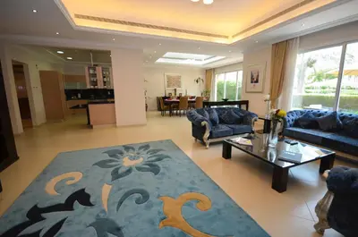 a living room with blue couches and a table at Coral Boutique Villas in Dubai