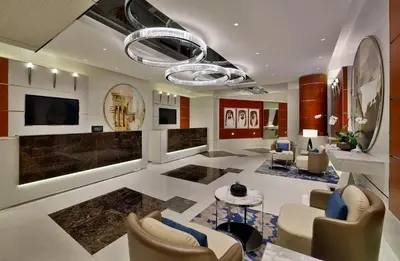 a living room with a couch and chairs and a television at Hilton Dubai The Walk in Dubai