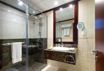 a bathroom with a sink and a shower at Hilton Dubai The Walk in Dubai
