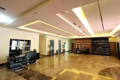a large lobby with chairs and a hair salon at Xclusive Maples Hotel Apartment in Dubai