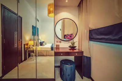 a room with a mirror and a desk and a bed at First Central Hotel Suites in Dubai