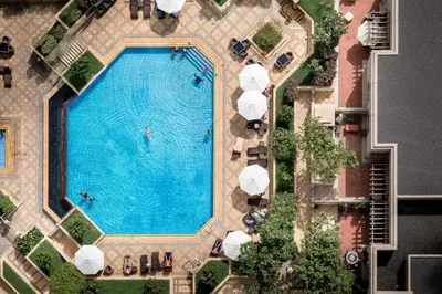 an overhead view of a swimming pool with umbrellas at Maison Privee - Exclusive Apt with Burj Khalifa Next Door in Dubai