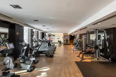 a gym with a bunch of treadmills and machines at Maison Privee - Exclusive Apt with Burj Khalifa Next Door in Dubai
