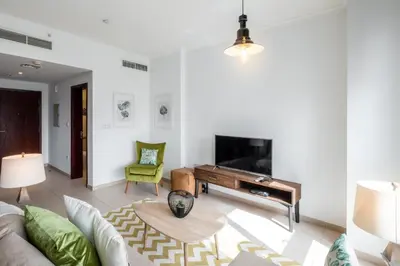 a living room with a couch and a piano at Maison Privee - Exclusive Apt with Burj Khalifa Next Door in Dubai