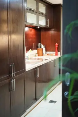 a kitchen with wooden cabinets and a counter top at Elite Royal Apartment - Burj Residences Tower 5 in Dubai