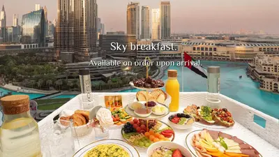 a table with plates of food on top of a balcony at Elite Royal Apartment - Burj Residences Tower 5 in Dubai