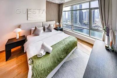 a bedroom with a large bed and a large window at Park Island, Dubai Marina in Dubai