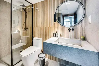 a bathroom with a toilet and a sink and a mirror at Park Island, Dubai Marina in Dubai