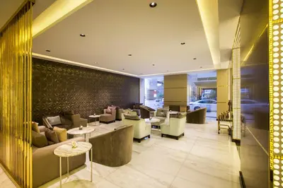 a lobby of a hotel with couches and tables at The Tower Plaza Hotel Dubai in Dubai