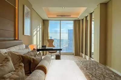 a hotel room with a couch and a large window at Renaissance Business Bay Hotel, Dubai in Dubai