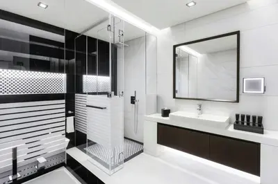 a white bathroom with a sink and a mirror at Renaissance Business Bay Hotel, Dubai in Dubai