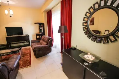 a living room with a couch and a mirror at 2br Beach front Sea View in Dubai