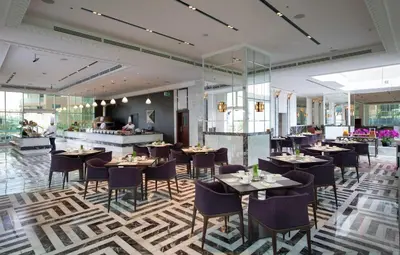 a restaurant with tables and chairs in a room at Stella Di Mare Dubai Marina Hotel in Dubai