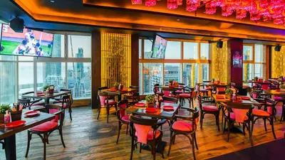 a restaurant with tables and chairs with a view at Stella Di Mare Dubai Marina Hotel in Dubai