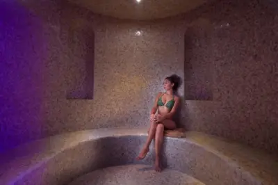 a woman sitting in a tub in a room at Stella Di Mare Dubai Marina Hotel in Dubai