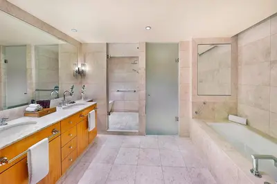 a bathroom with two sinks and a tub and a shower at Ritz Carlton Residences DIFC Downtown Dubai in Dubai