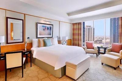a bedroom with a large white bed and a large window at Ritz Carlton Residences DIFC Downtown Dubai in Dubai