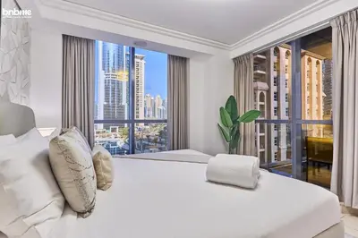 a bedroom with a large white bed with a large window at bnbmehomes - Gold Crest Views 2 in Dubai