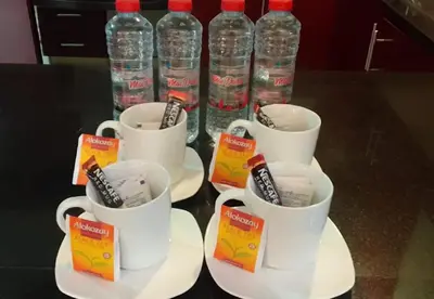 a group of cups of water and bottles of water at Murjan Suites Waterfront Jumeirah Beach Residence The Walk & Dubai Eye & Beach & Marina in Dubai
