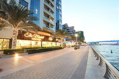 a street in a city with a river and buildings at Pearl Marina Hotel Apartments in Dubai