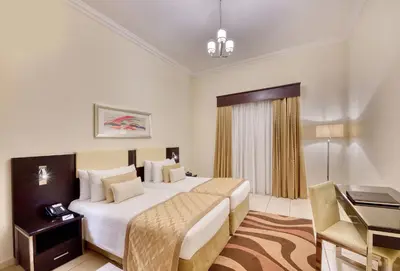 a hotel room with a bed and a desk at Pearl Marina Hotel Apartments in Dubai