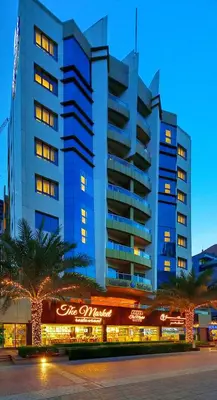 a tall blue building with a sign in front of it at Pearl Marina Hotel Apartments in Dubai