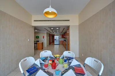 a dining room with a table and chairs at J5 Villas Holiday Homes Barsha Gardens in Dubai