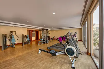 a gym with treadmills and elliptical machines at J5 Villas Holiday Homes Barsha Gardens in Dubai