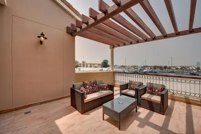 a patio with chairs and a table on a balcony at J5 Villas Holiday Homes Barsha Gardens in Dubai