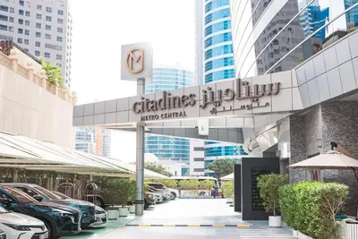 a dealership with cars parked in a parking lot at Citadines Metro Central Dubai in Dubai
