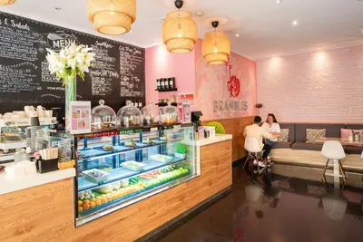 a restaurant with a display case with food at Citadines Metro Central Dubai in Dubai