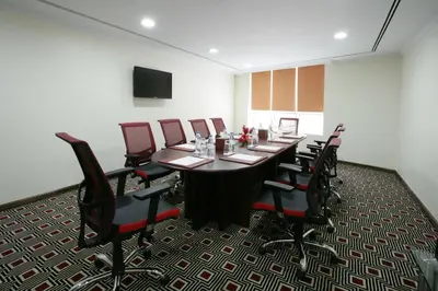 a conference room with a long table and chairs at Elite Byblos Hotel in Dubai