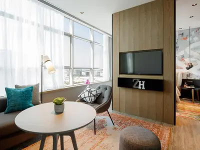 a living room with a couch and a table at Zabeel House The Greens by Jumeirah in Dubai