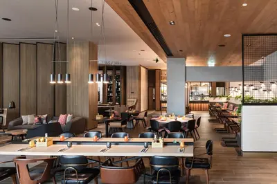 a restaurant with tables and chairs and a bar at Zabeel House The Greens by Jumeirah in Dubai