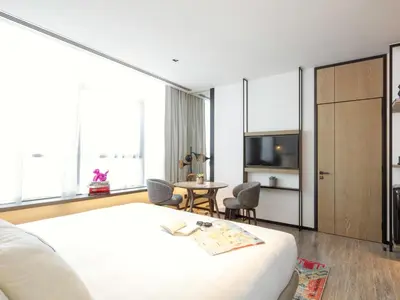 a bedroom with a bed and a table and chairs at Zabeel House The Greens by Jumeirah in Dubai