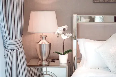 a lamp on a table next to a bed at Elite Royal Apartment - Full Burj Khalifa & Fountain View - Crystal in Dubai